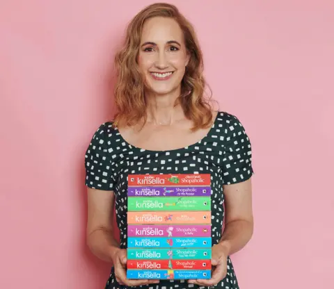 Sophie Kinsella pictured with her Shopaholic series of novels (Getty Images / Sarah Cresswell).