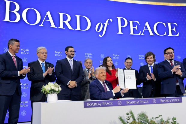 President Trump holds up his signature during the 'Board of Peace' signing ceremony at the World Economic Forum in Davos, Switzerland, on Jan. 22, 2026.