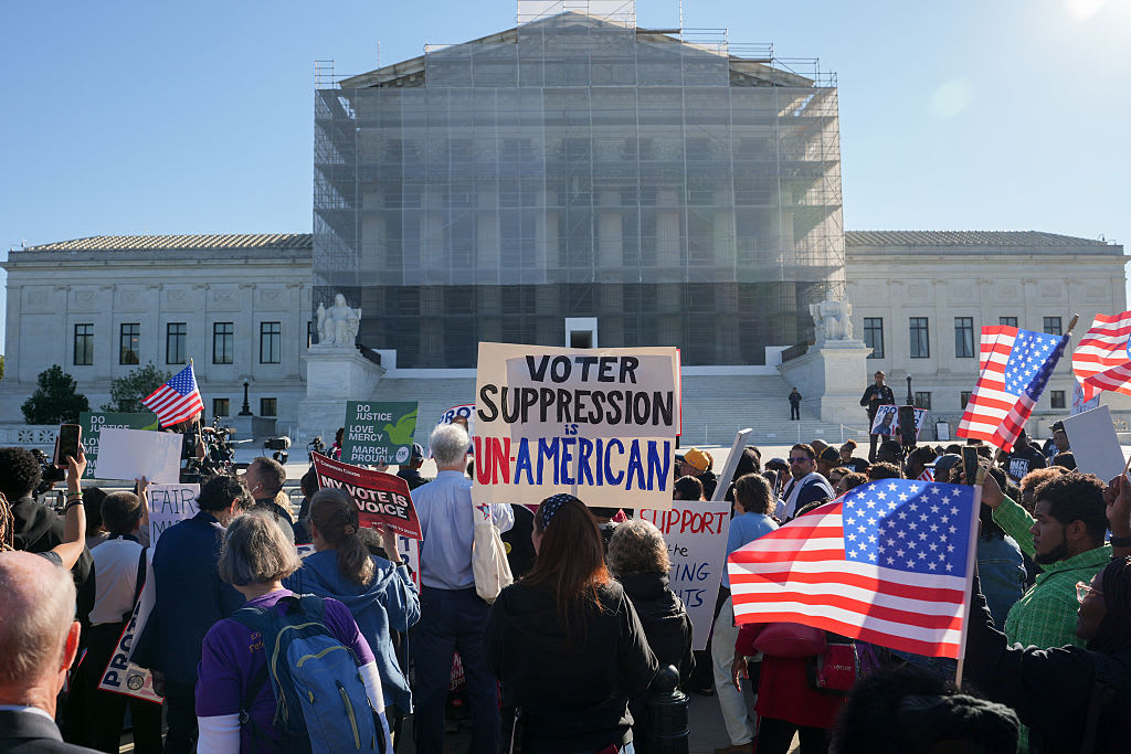 Voting rights demonstrators gather outside the U.S. Supreme Court.