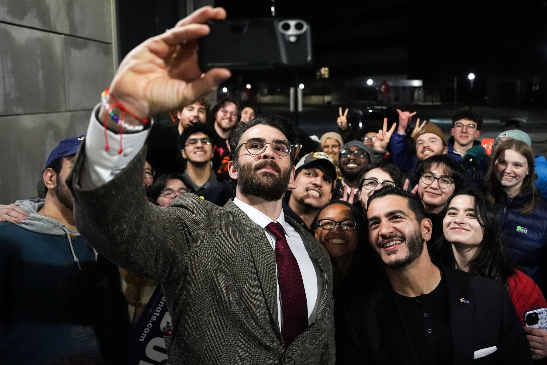 Hasan Piker and Michigan Senate candidate Abdul El-Sayed take a selfie with students at a University of Michigan event on April 7, 2026.
